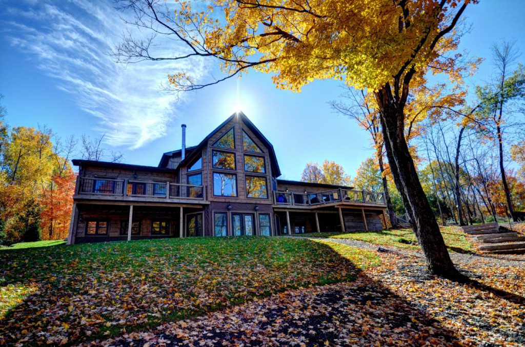 large cabin with a fireplace in haliburton